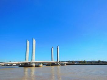 View of bridge over sea against blue sky