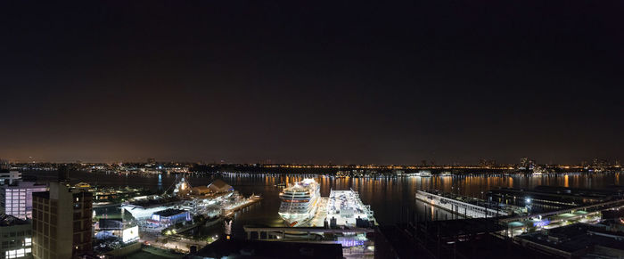 High angle view of illuminated cityscape against sky at night