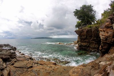 Scenic view of sea against sky with cliff 