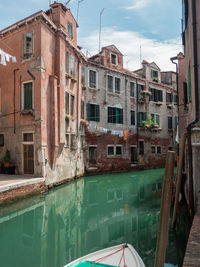 Canal by buildings in venice, italy