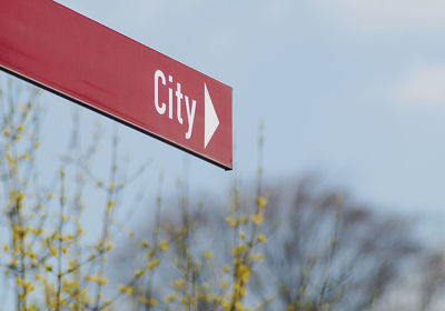 Low angle view of sign board against sky