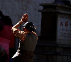 Rear view of woman standing outdoors