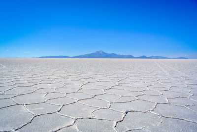 Scenic view of desert against blue sky