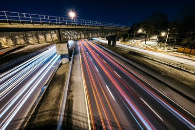 High angle view of light trails on road at night