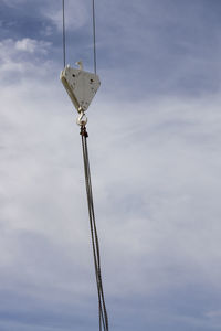 Low angle view of crane against sky