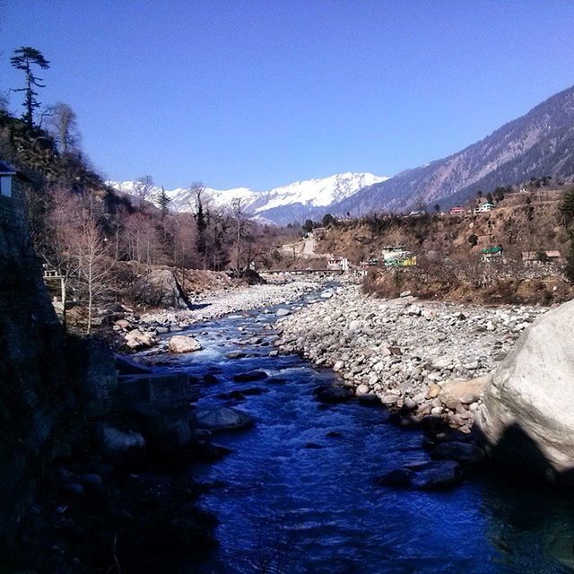 clear sky, mountain, water, tranquil scene, tranquility, scenics, beauty in nature, blue, nature, stream, copy space, rock - object, river, landscape, non-urban scene, lake, mountain range, idyllic, day, sky