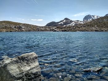 Scenic view of mountains and river against sky