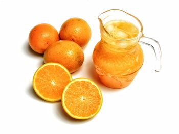 Close-up of orange fruit against white background