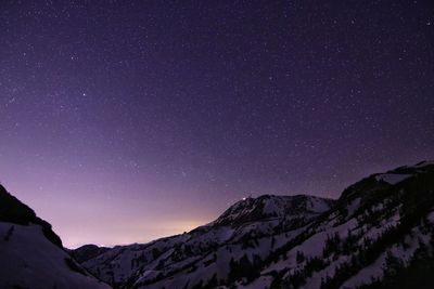 Low angle view of mountain against sky at night