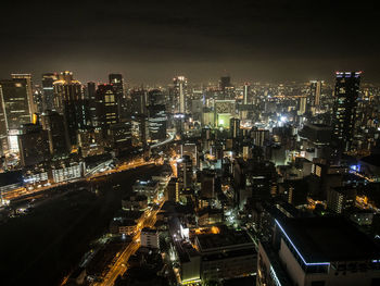 Aerial view of city lit up at night