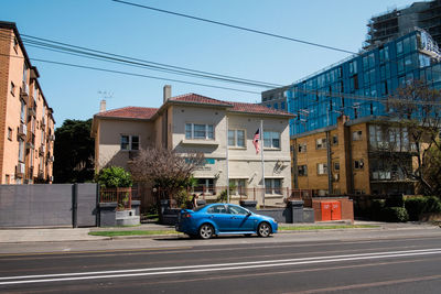 Cars on street against buildings in city