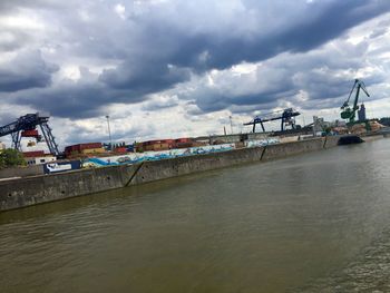 View of harbor against cloudy sky