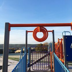 Metallic railing against blue sky