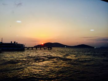 Scenic view of sea against sunset sky