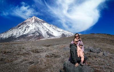 Full length of woman on snowcapped mountain against sky