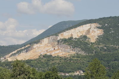 Built structure on mountain against cloudy sky