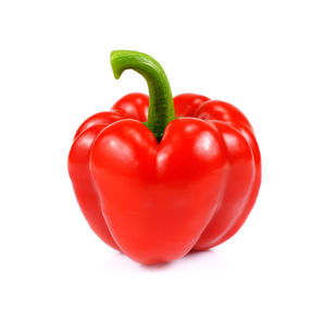 Close-up of red bell peppers against white background