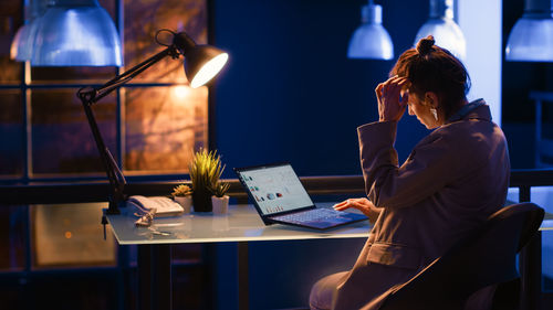 Businesswoman using digital tablet at table