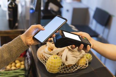 Midsection of man using mobile phone