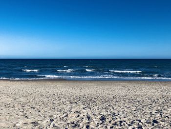 Scenic view of sea against clear blue sky