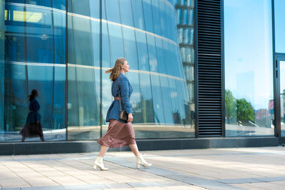 Successful happy woman on her way to work in street. confident business woman