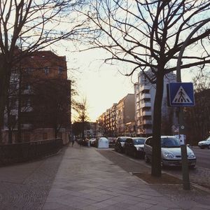 Road leading towards buildings in city