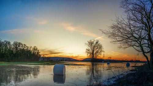 Scenic view of lake against sky during sunset