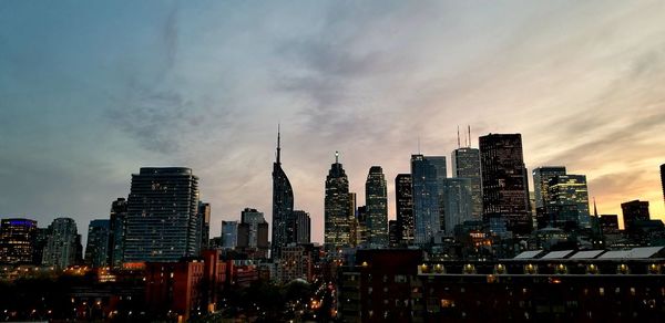 View of buildings against cloudy sky during sunset