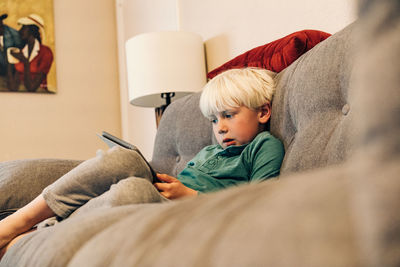 Young boy doing school work on tablet