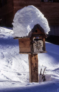 Public mailbox on snowcapped field at night