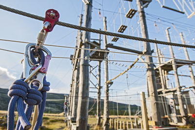 Close up of pulley on a metal wire at high rope obstacle course