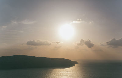 Scenic view of sea and mountains against sky during sunset