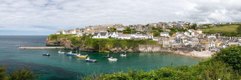 Panoramic view of townscape by sea against sky