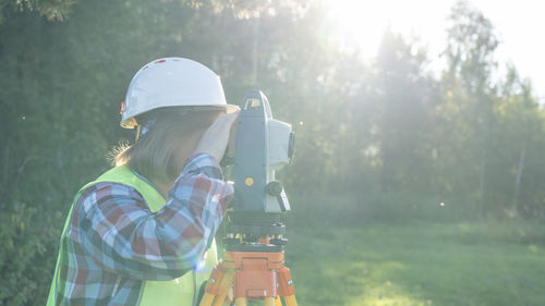 Rear view of man using mobile phone