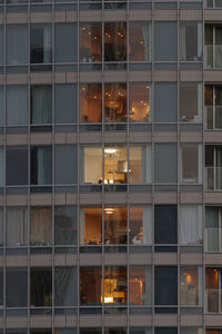 Full frame shot of modern glass building at night