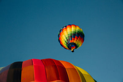 Low angle view of hot air balloon against blue sky