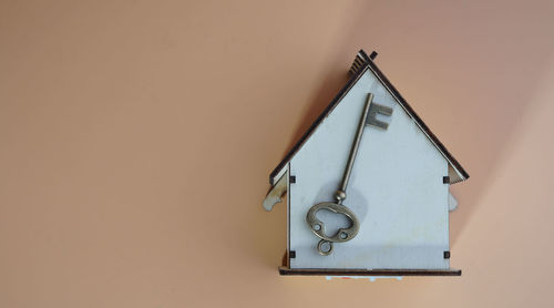 Close-up of clock on table against wall