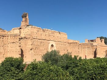 Low angle view of historical building against clear blue sky