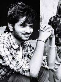 Portrait of smiling young man sitting outdoors