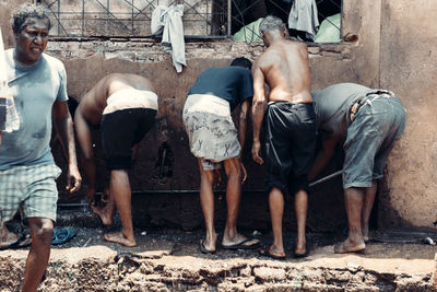 People washing legs outdoors