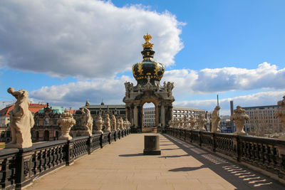 Statue of historic building against cloudy sky