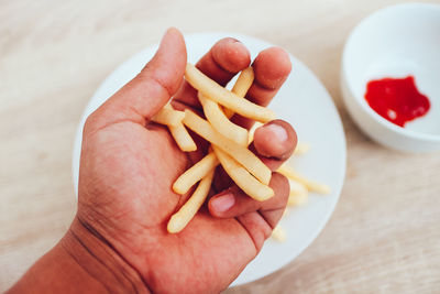 Close-up of hand holding burger