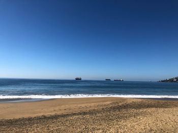 Scenic view of sea against clear blue sky