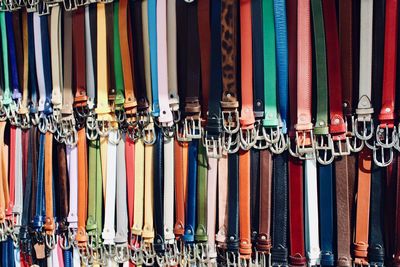 Leather belts hanging on stall