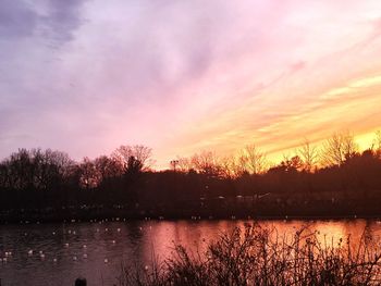 Scenic view of lake against romantic sky at sunset