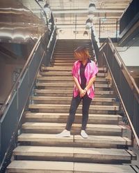 Low angle view of woman walking on staircase