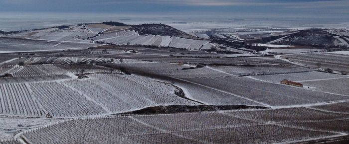 Aerial view of landscape against sky during winter