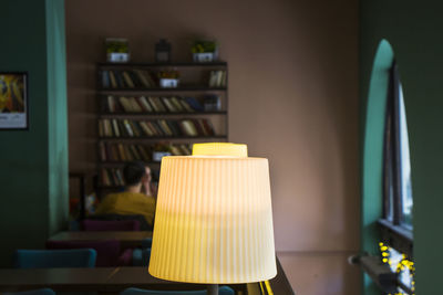 Close-up of illuminated lamp on table at home