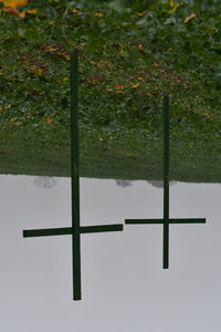 Cross on field against sky