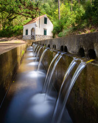 Water pouring in streams into a concrete levada